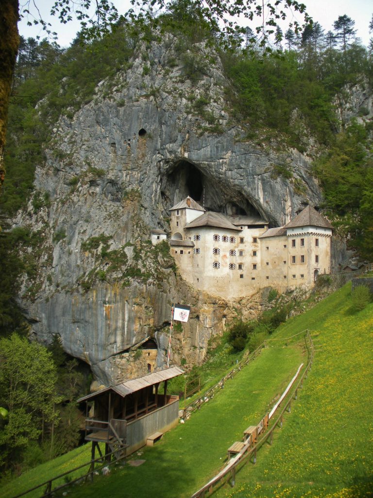 Predjama Castle jutting out of a mountain cave