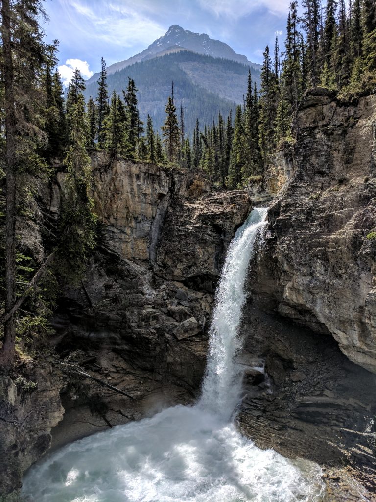 Stanley Falls with a mountain peak in the background