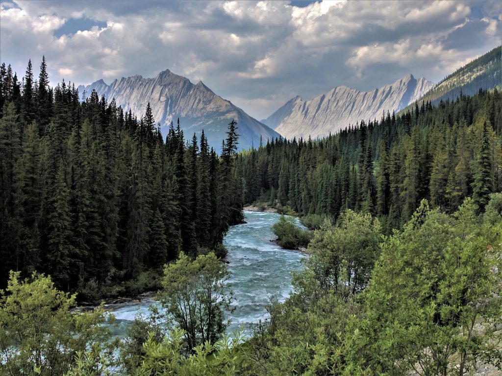 A stream leading to 2 far-off mountains