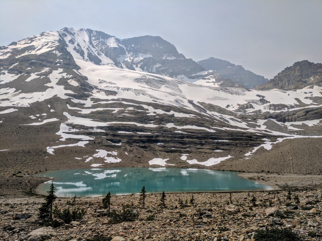 A small glacial tarn in front of mountains