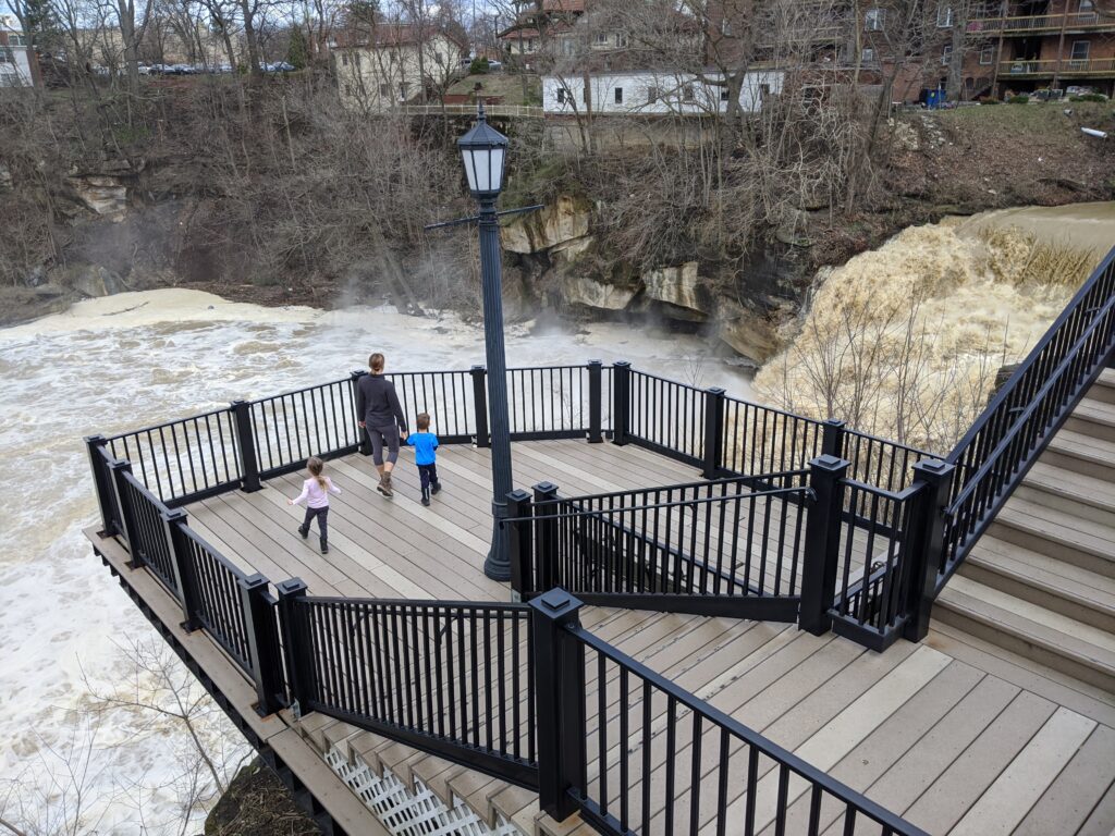 A mother and children on a platform looking at Falls of the Black River