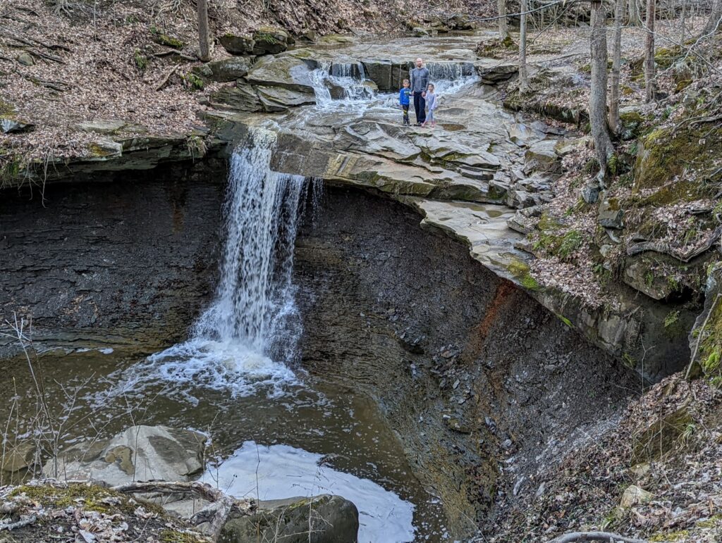 A man and children standing at the top of Blue Hen Falls