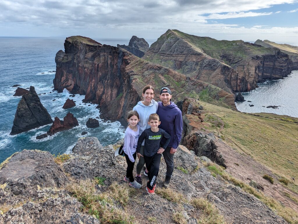 A family standing in front of a rugged coastline at Sao Lourenco on Madeira, Portugal