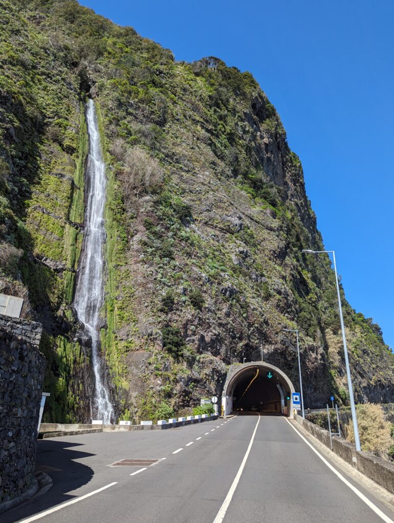 A waterfall next to a tunnel on Madeira, Portugal