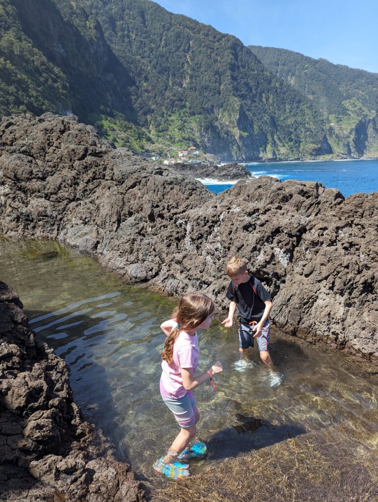 Kids playing in a shallow pool of water in Seixal, Madeira