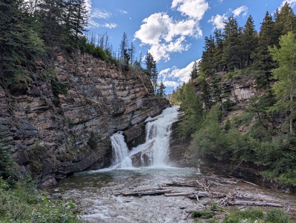 Two rocky waterfalls on a semi cloudy day in Waterton National Park