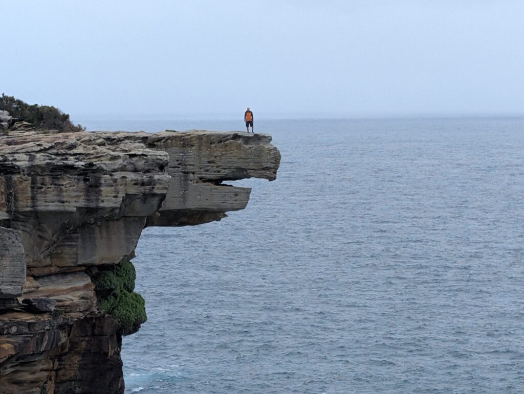 A man stands on a rock that looks like an eagle