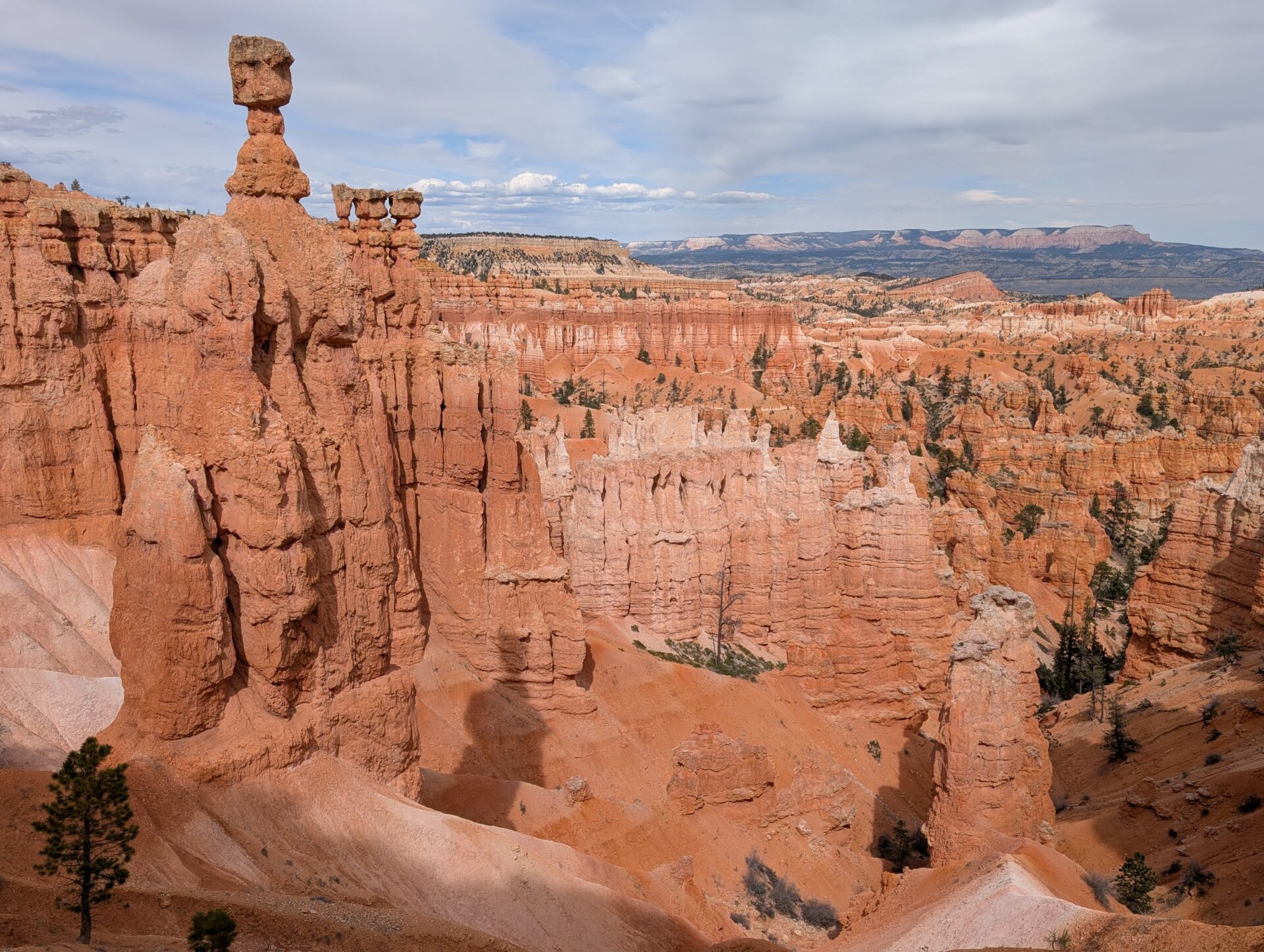 A skinny orange rock formation sticking up above the skyline with many others below it