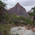 A sharp, symmetrical mountain with a river in the foreground