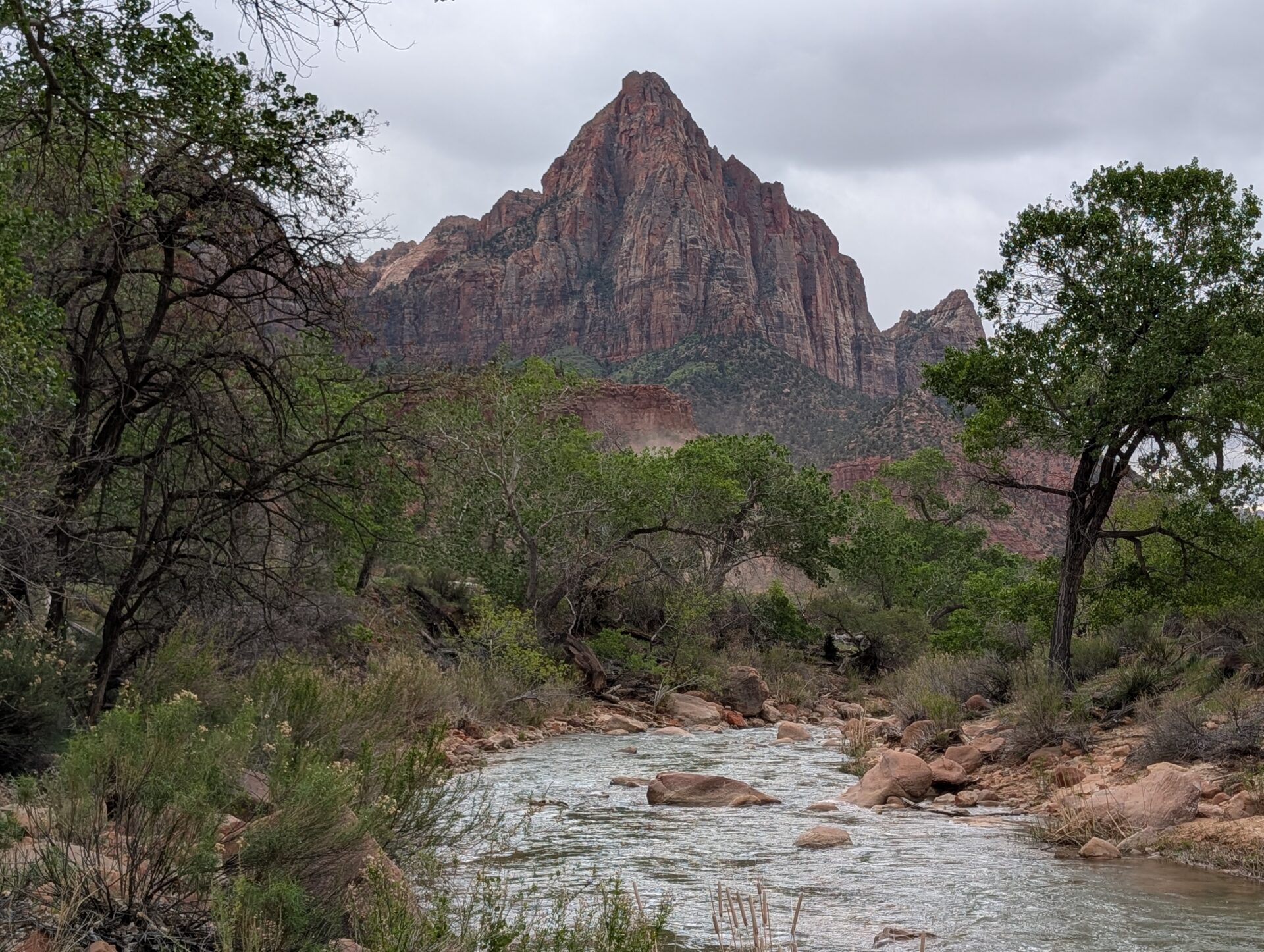 A sharp, symmetrical mountain with a river in the foreground