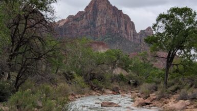 A sharp, symmetrical mountain with a river in the foreground