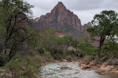 A sharp, symmetrical mountain with a river in the foreground