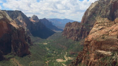 An elevated view looking down a deep, wide canyon on a cloudy day