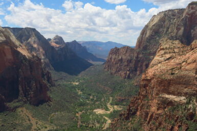 An elevated view looking down a deep, wide canyon on a cloudy day