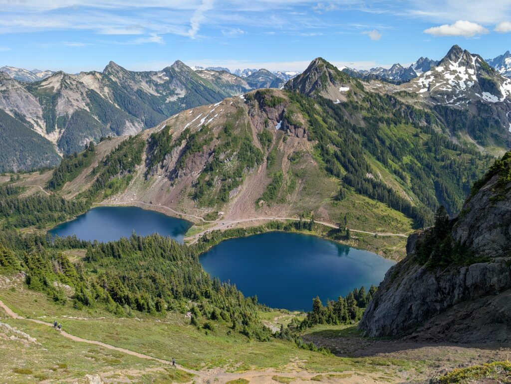 An elevated view of two lakes with mountain peaks in the North Cascades